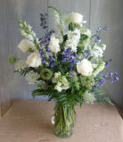 Blue and white flowers arranged in a vase.