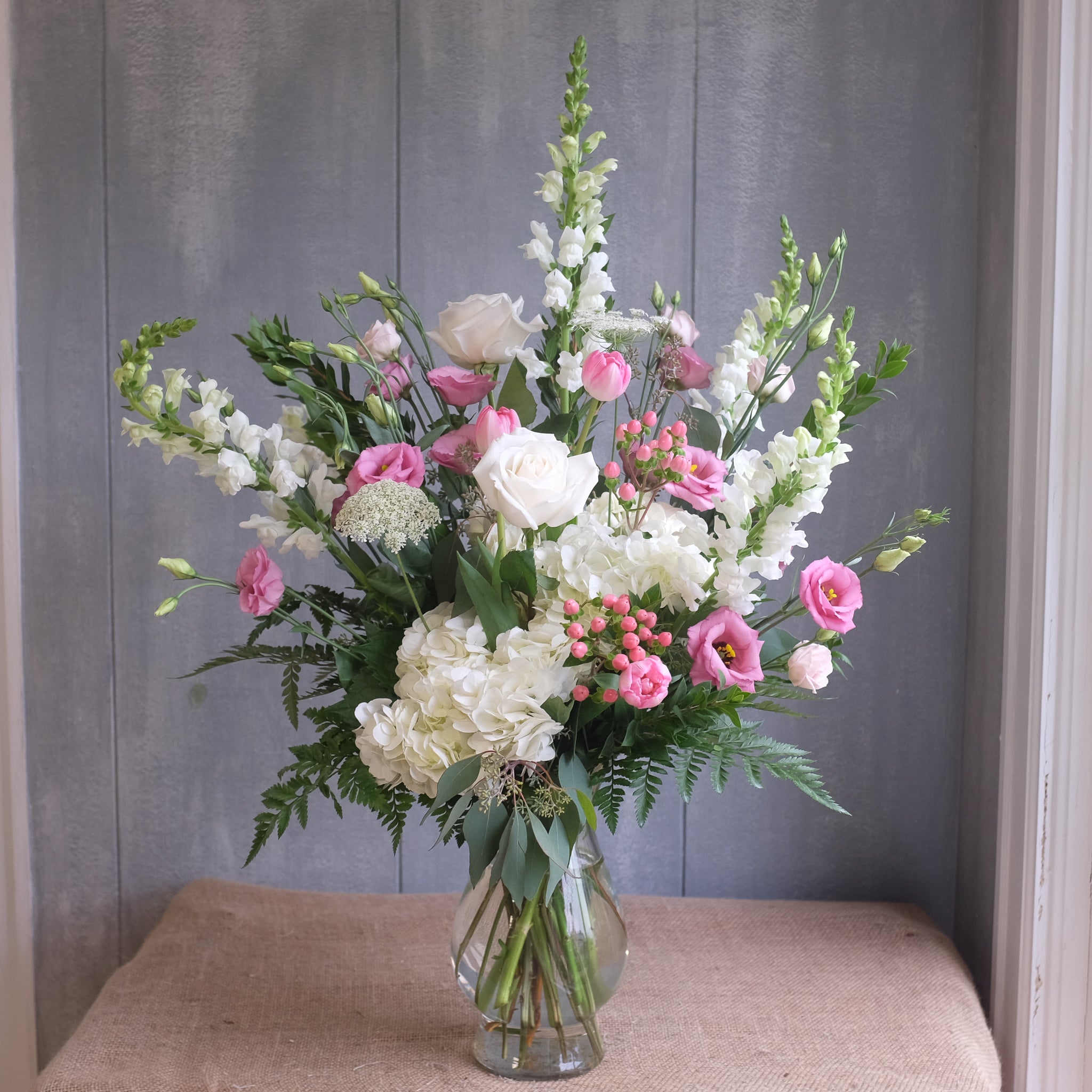 tall and elegant floral arrangement with roses, lisianthus, hydrangea, and stock by Michler's Florist in Lexington, KY