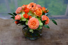 Ranunculus bowl: orange ranunculus and spray roses designed with hydrangea | Michler's Florist