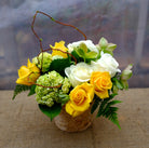 Seattle Flower Arrangement: Yellow Roses, green Hydrangea, Hellebore, and Willow. Designed by Michler's Florist in Lexington, KY