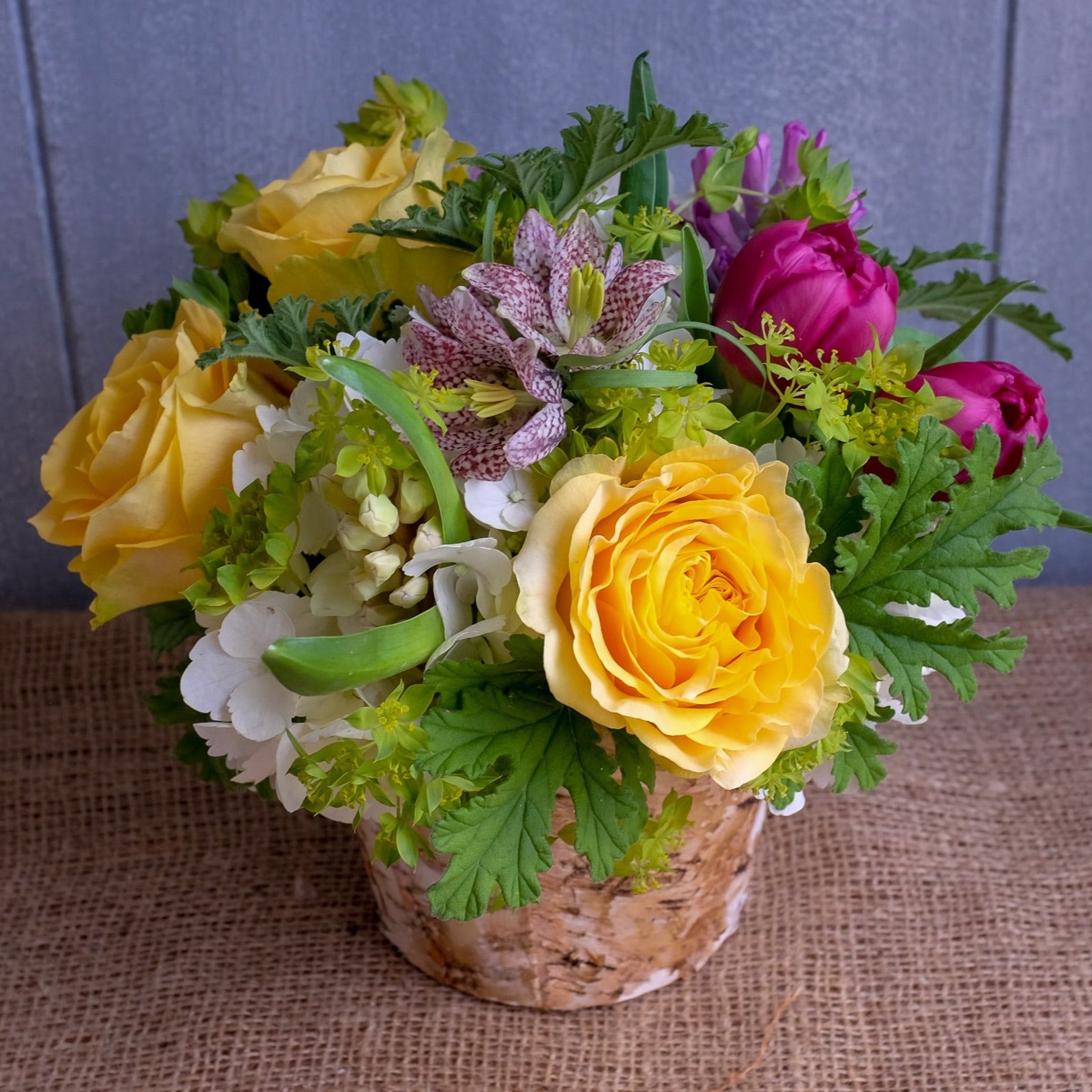 Shenandoah Flower Bouquet with Checkered Fritillaria, Double Tulips, and Scented Geranium Foliage by Michler's Florist