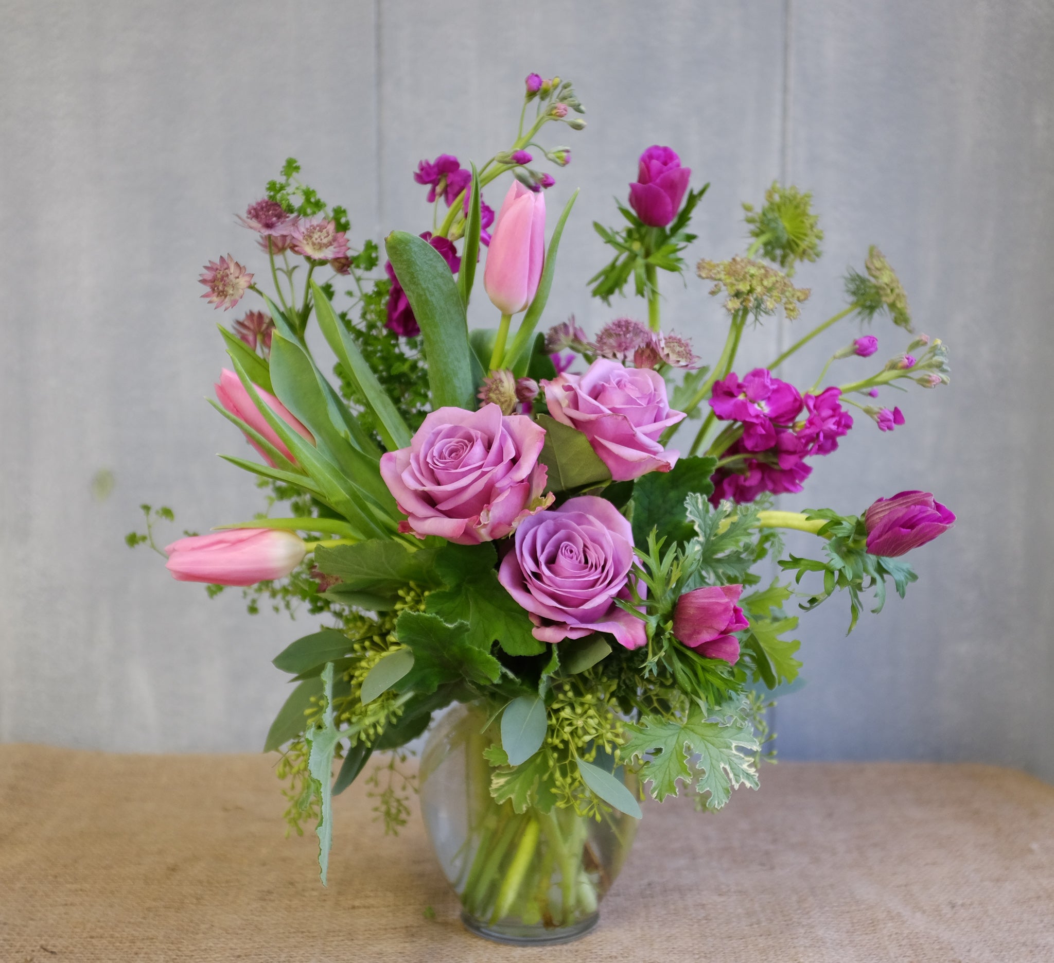 Flower bouquet with lavender roses, pink tulips, fuchsia anemones by Michler's Florist
