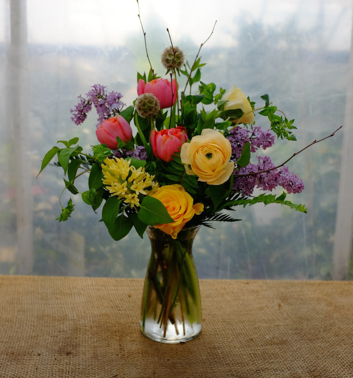 Somerset Flower Bouquet: Pink Tulips, Yellow Ranunculus, Scabiosa Pods and Lilac Flowers.  Designed in Lexington, KY by Michler's Florist