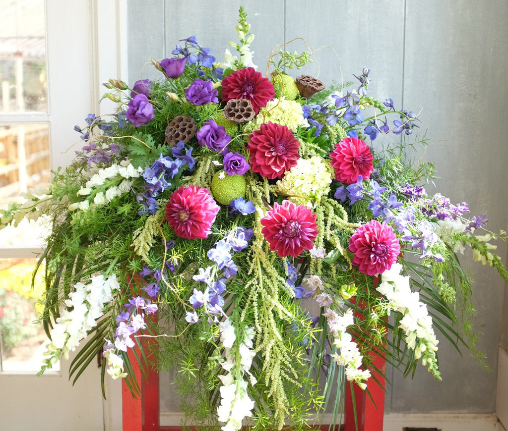 Casket Spray with Purple Dahlias, Larkspur, Lisianthus, and Snap Dragons.  Michler's Florist