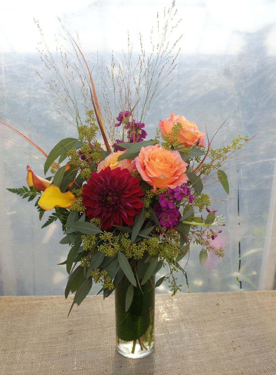Strathmore: Flower arrangement with burgundy Dahlias, orange Calla Lilies, orange Roses and grasses - Michler's Florist