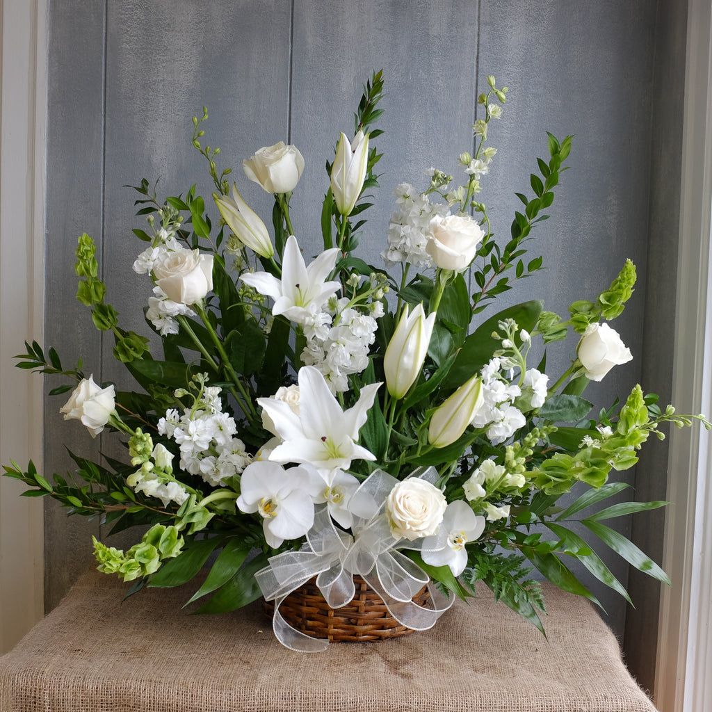 White and green funeral basket by Michler's Florist