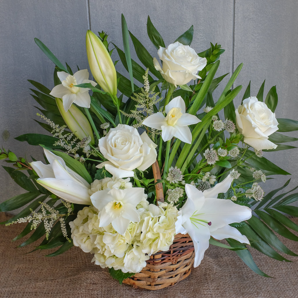 floral funeral basket with roses, lilies, and hydrangea by Michler's Florist in Lexington, KY