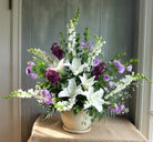 Purple and white floral spray arrangement
