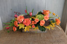 warm toned autumn arrangement with orange roses