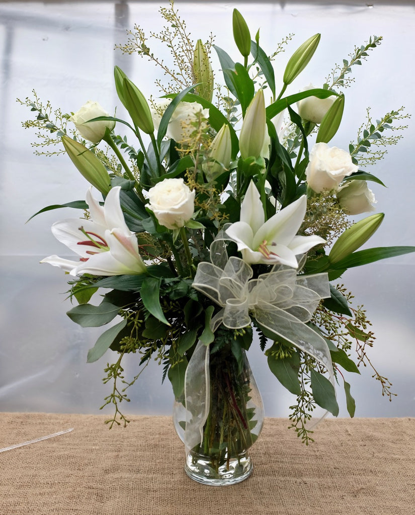 Carrara: Vase arrangement with white lilies, white roses, soft grey foliage.  Designed by Michler's Florist in Lexington, KY
