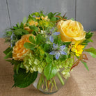 Yellow rose garden bouquet with a touch of blue.