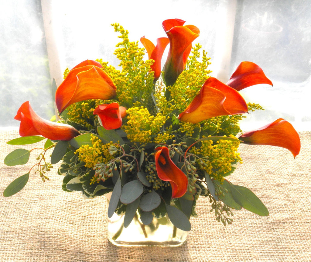 Floral Arrangement by Michler's Florist  with red Calla Lilies and eucalyptus