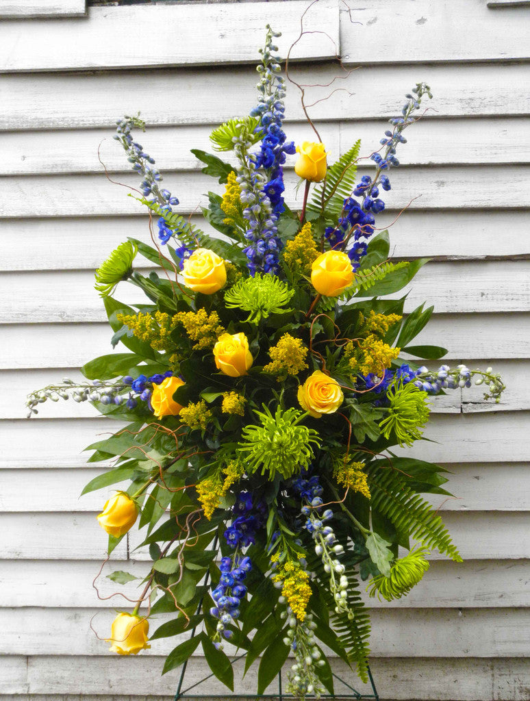 Yellow Farewell Easel Spray with Yellow Roses and Blue Delphinium Designed by Michler's Florist in Lexington, KY